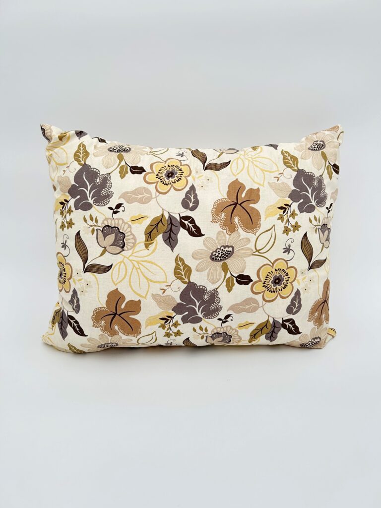 Floral gray and beige throw pillow handmade for elegantly decorating the sofa.