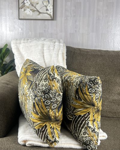 Handmade brown throw pillow set of 2 with jungle print sitting on sofa