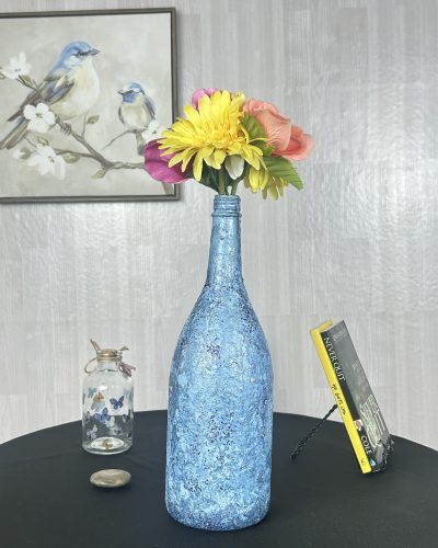 Hand painted bright blue vase with colorful bouquet inside