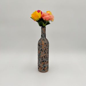 Gray and orange unique flower vase hand painted with a bouquet inside.