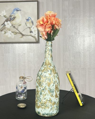 Hand painted green and gold vase with peach flowers inside