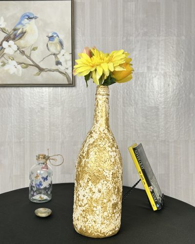 Hand painted gold vase with yellow flower bouquet inside