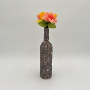 Brown vase with swivels of white hand painted with flowers inside.