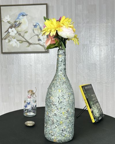 Hand painted olive green vase with a bright bouquet inside