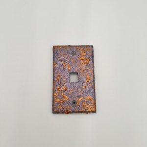 Purple light switch cover with traces of orange