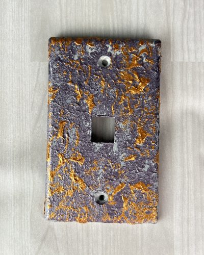 Hand painted purple light switch cover with orange streaks