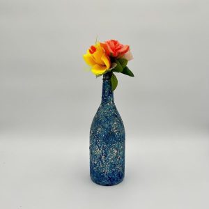 Hand painted royal blue vase with bright flowers inside
