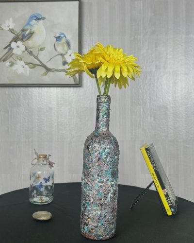 Hand painted turquoise and purple splatter vase with a yellow flowers