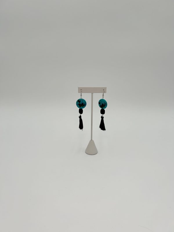 Turquoise and black tassel earrings with black butterfly in center of bead