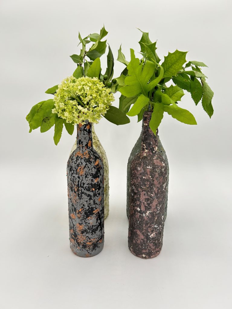 Beautiful greenery in unique glass vases