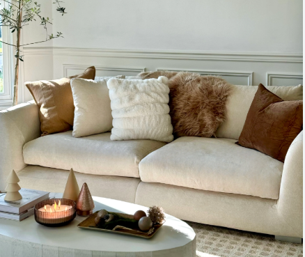 Beige sofa with brown pillows styled on it