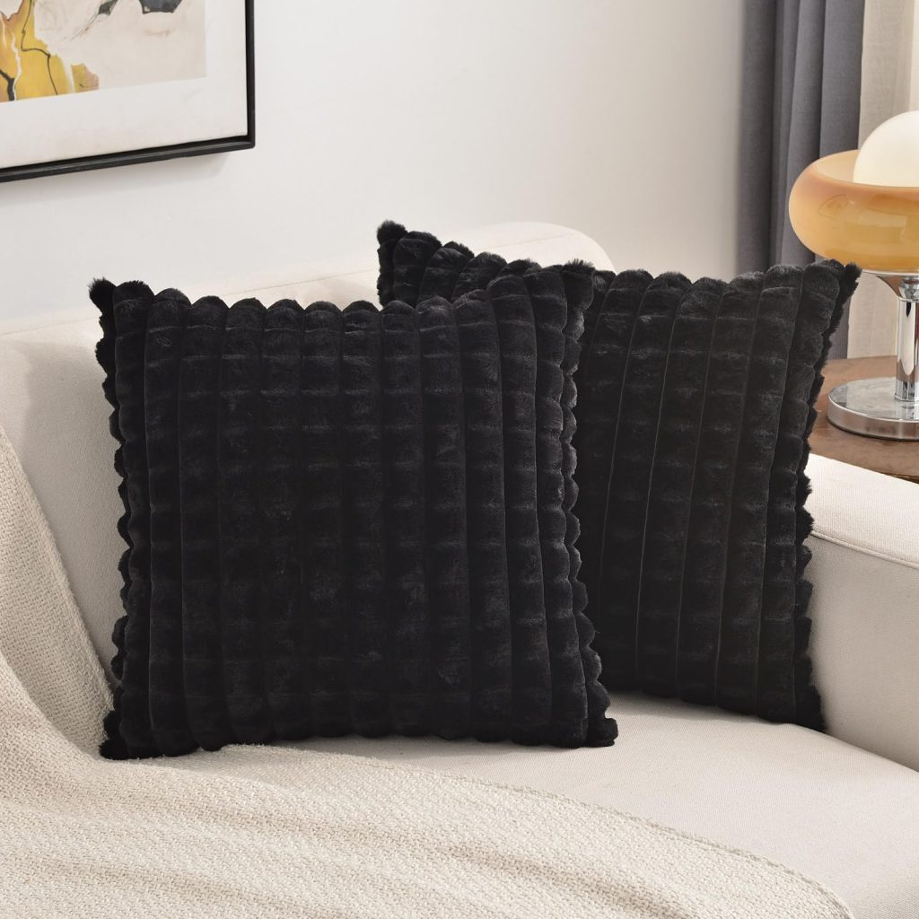 Black decorative throw pillow set of 2 sitting on white sofa