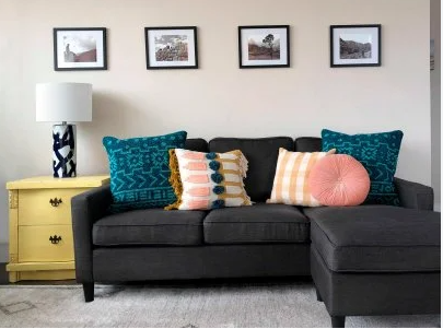 Black sofa with bright decorative throw pillows