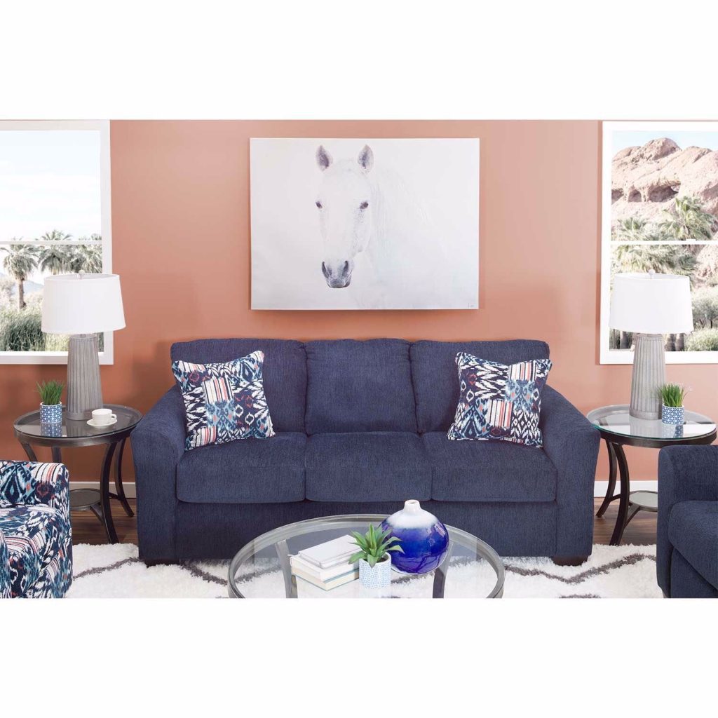 Blue sofa with blue and white print throw pillows