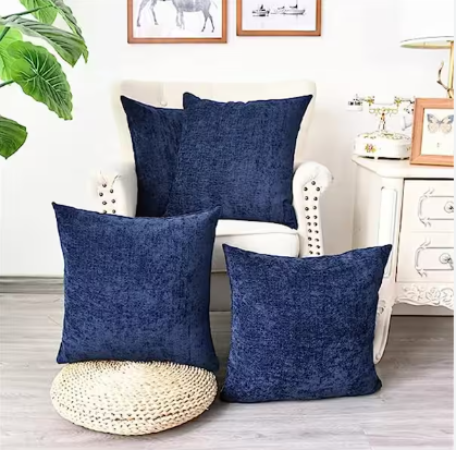 Blue throw pillow set of 4 sitting on white chair