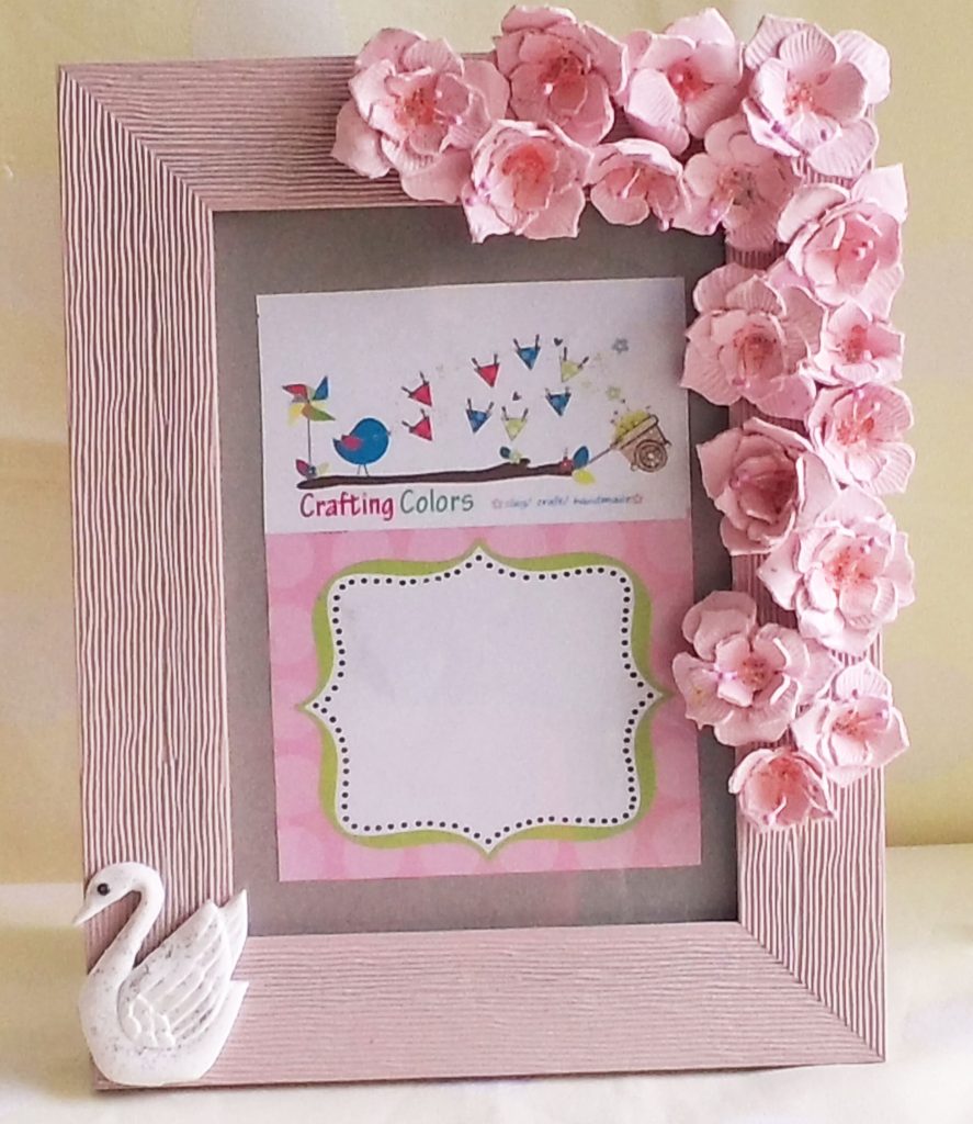 Pink handmade decorative picture frame with accessorized border, a great gift for crafters.