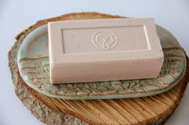 Handmade soap dish with bar of soap placed on it.