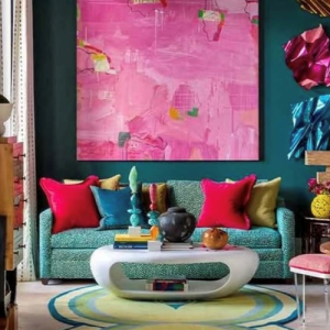 A beautiful, colorful living room filled with vibrant pillows and wall art