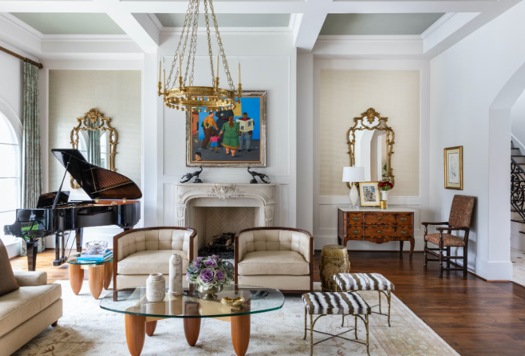 Art deco inspired living room with tan chairs and colorful painting