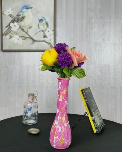 Hand painted pink vase with colorful bouquet sitting on table
