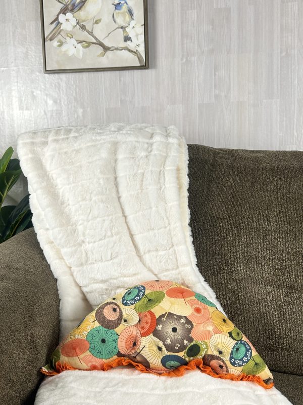 Handmade umbrella shaped orange throw pillow on brown sofa