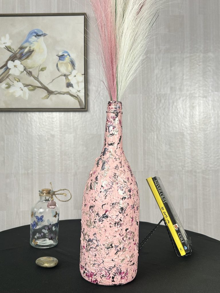 Hand painted candy pink vase with streaks of black and gray with faux pampas inside